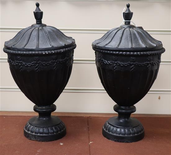 A pair of cast iron urns and covers height 37cm